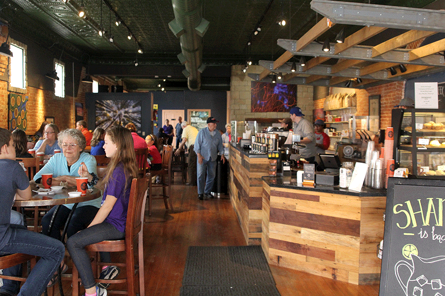 On a Saturday morning, Groundhouse Coffee is filled with customers enjoying drinks, crepes and other baked goods.