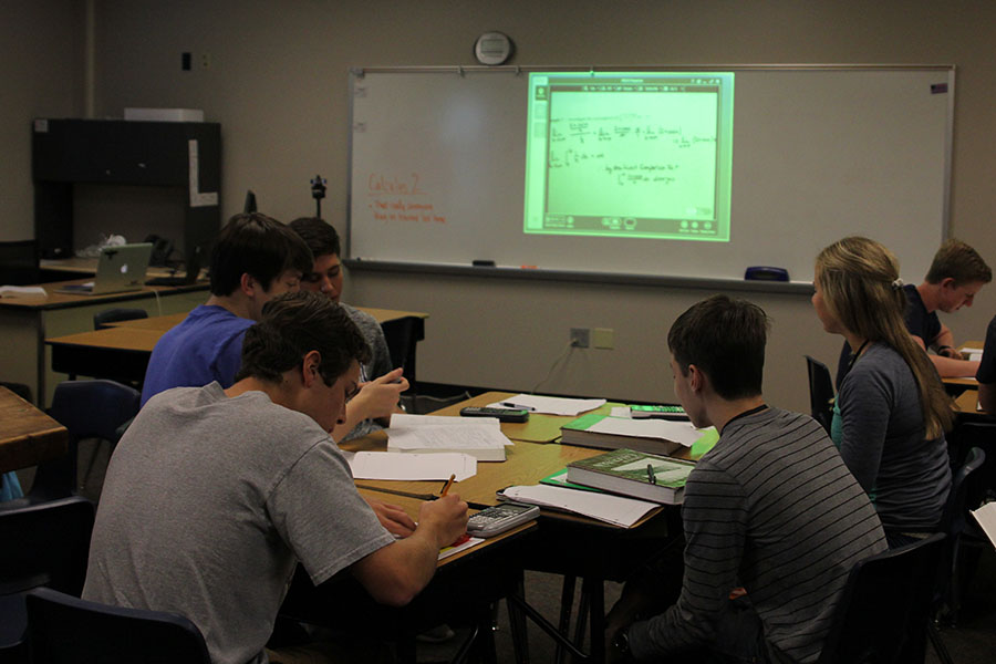 Mill Valley students work on assignments while math teacher Brian Rodkey's notes are displayed on a screen.