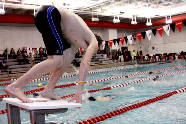 Sophomore Nick Stack prepares to dive off the block.