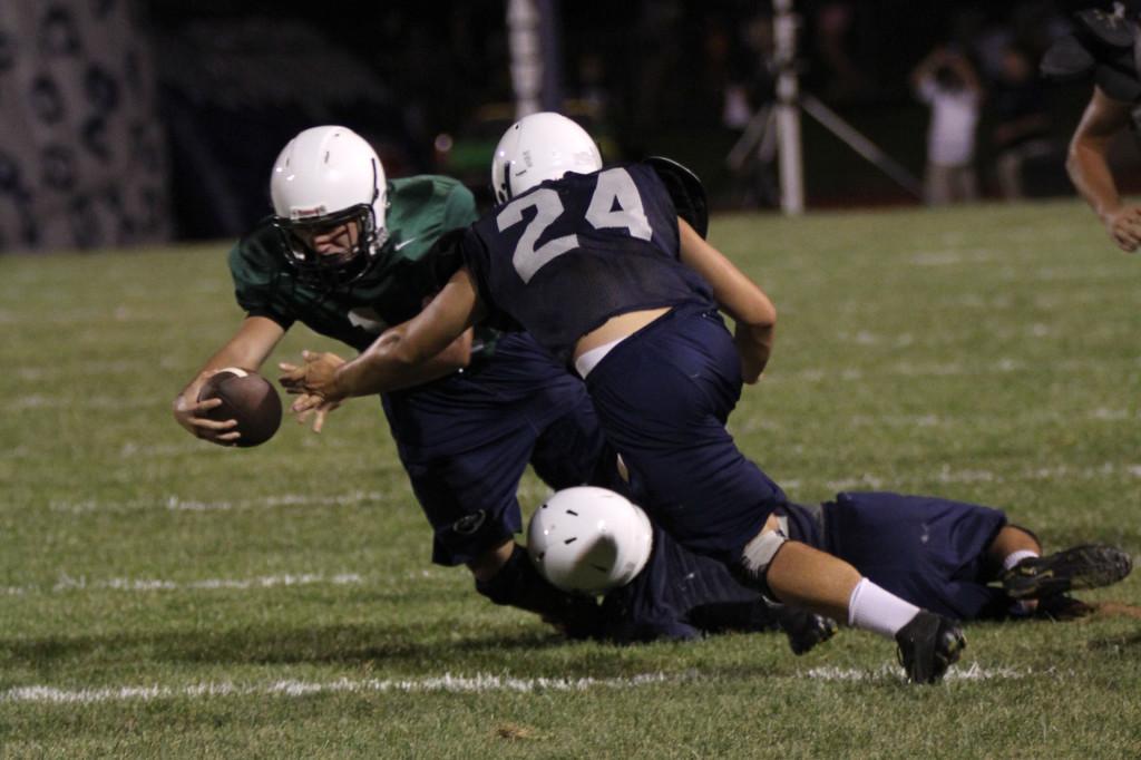 Arm extended, junior quarterback Ty Bryce attempts to gain a first down during the Mill Valley Nigh Lights scrimmage on Friday, August 30.
