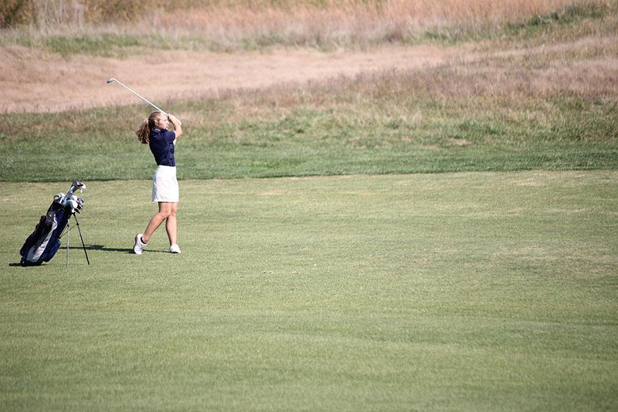 While hitting, freshman Meg Green follows through with her swing on Thursday, Oct. 10.