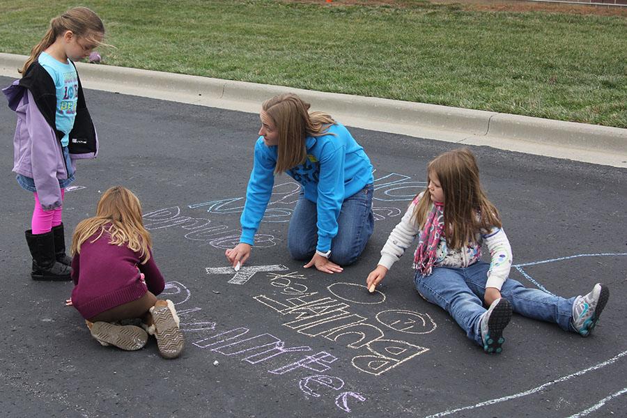 JagPRIDE member, junior Abby Taylor, wrote positive messages in chalk with Horizon Elementary students on Wednesday, Oct. 23. 
