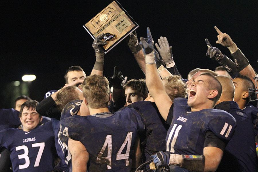 The football team celebrates its 38-6 victory over St. Thomas Aquinas in their regional game on Friday, Nov. 8. The team will play Blue Valley in their sectional game on Friday, Nov. 15.