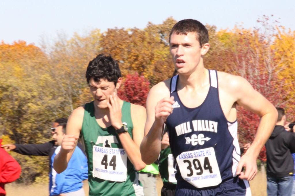 Passing a runner at the state cross country meet, CJ Meeks helps the boys team earn third place. The girls team also took third on Saturday, Nov. 2. 