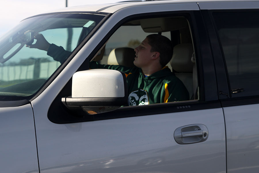 Preparing to drive home on Friday, Nov. 8, freshman Jacob Campbell adjusts his mirrors. Campbell completed a driver’s education course over the summer. 