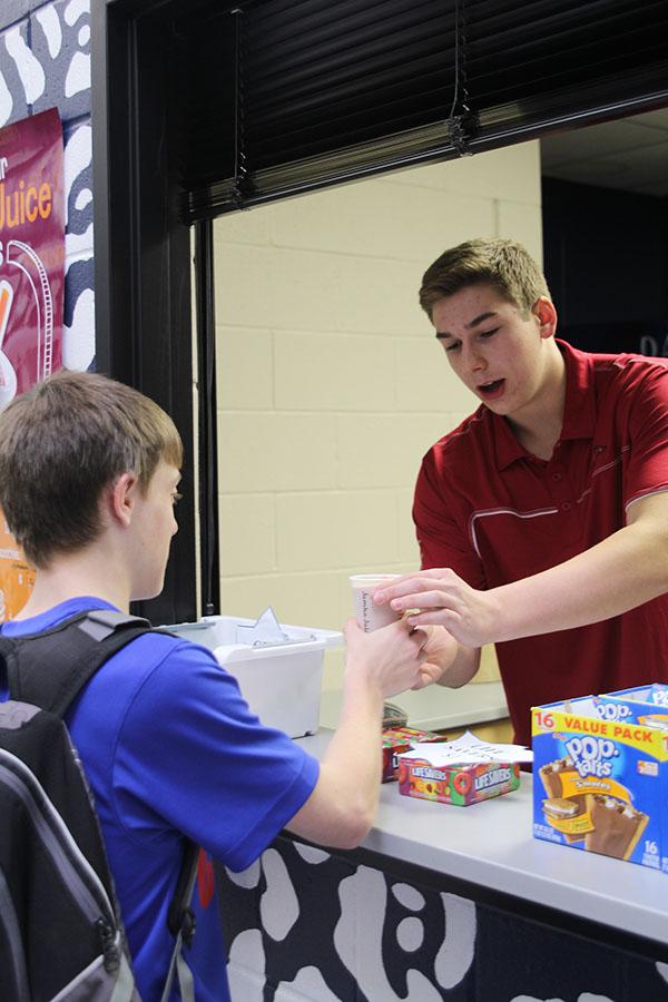 On its first day of business junior Chase Battes sells the first Jumbo Juice smoothie on Wednesday, Dec. 5.