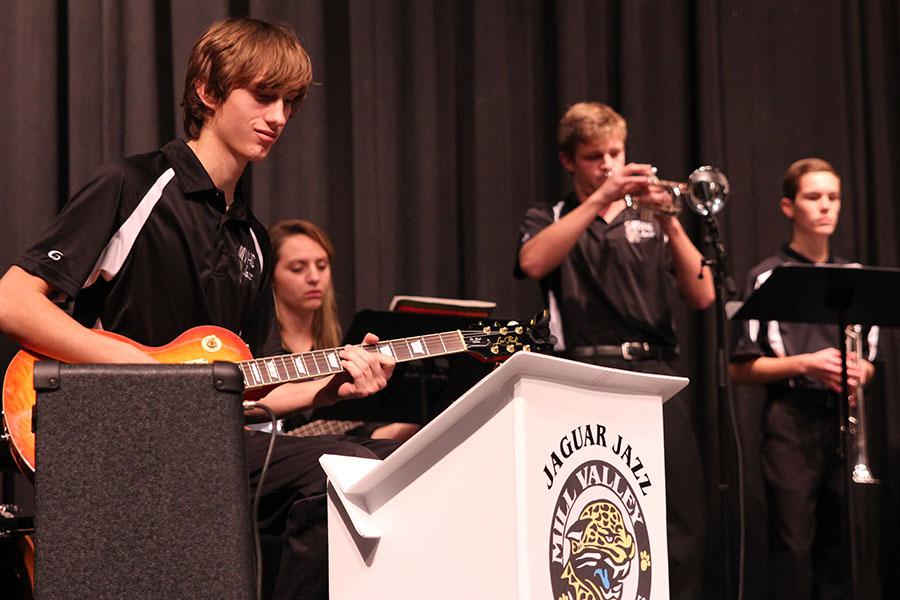 Accompanying the jazz band, senior Mastin Tapp plays electric guitar during the first jazz piece on Tuesday, Dec. 3.