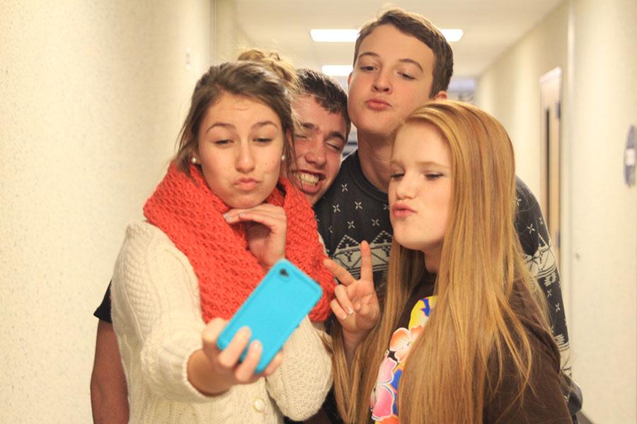 A+group+of+freshman+stop+to+pose+for+a+selfie+in+the+hallway+on+Thursday%2C+Dec.+5.