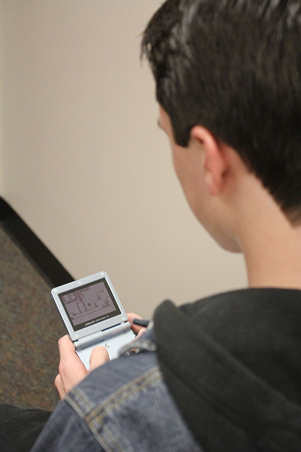 Junior Caleb Latas plays Pokémon on his Gameboy Color on Wednesday, Jan. 15. “The best part of Pokémon is catching them all,” Latas said.