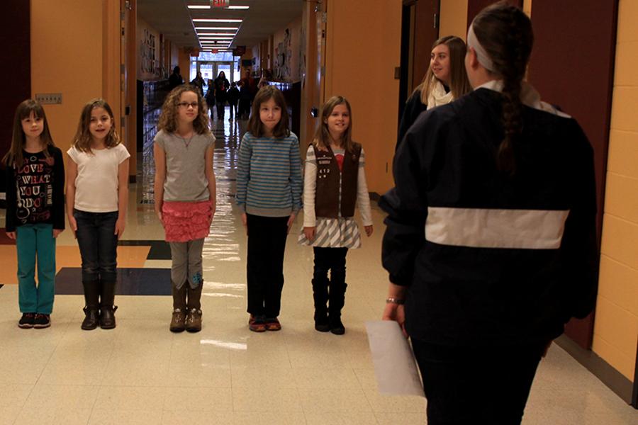 Junior Samantha Meyers teaches young Girl Scouts the halt command at Riverview Elementary on Wednesday, Jan. 8. 