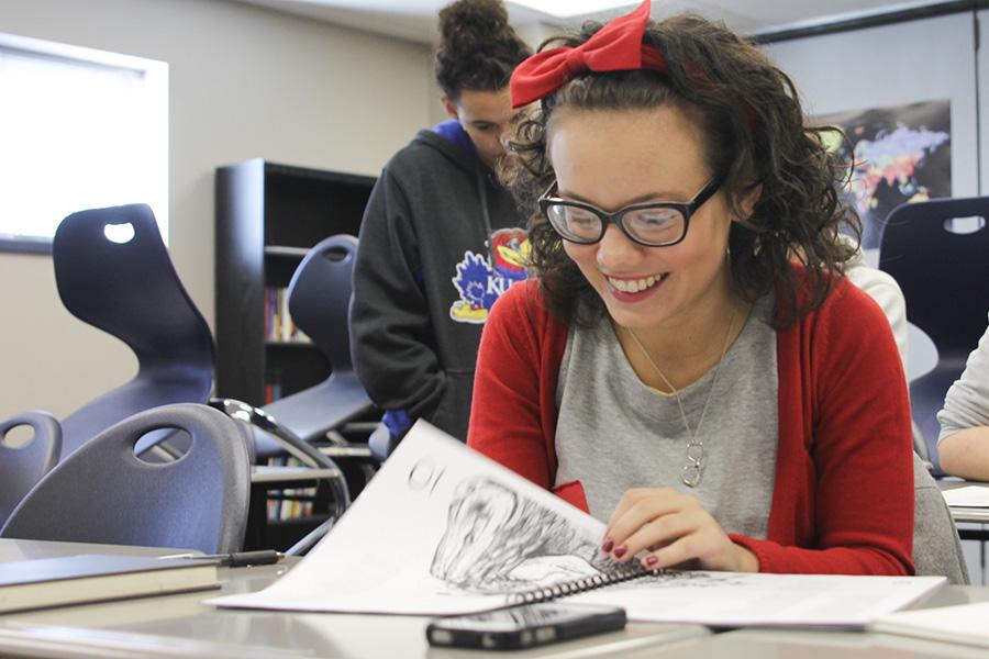 Senior literary magazine committee member Kara Lewis flips through a magazine demonstration at the first literary magazine meeting in sponsor Anna Nelsons room Thursday, Jan. 23. The new magazine will support creative works such as short stories, poetry and art.