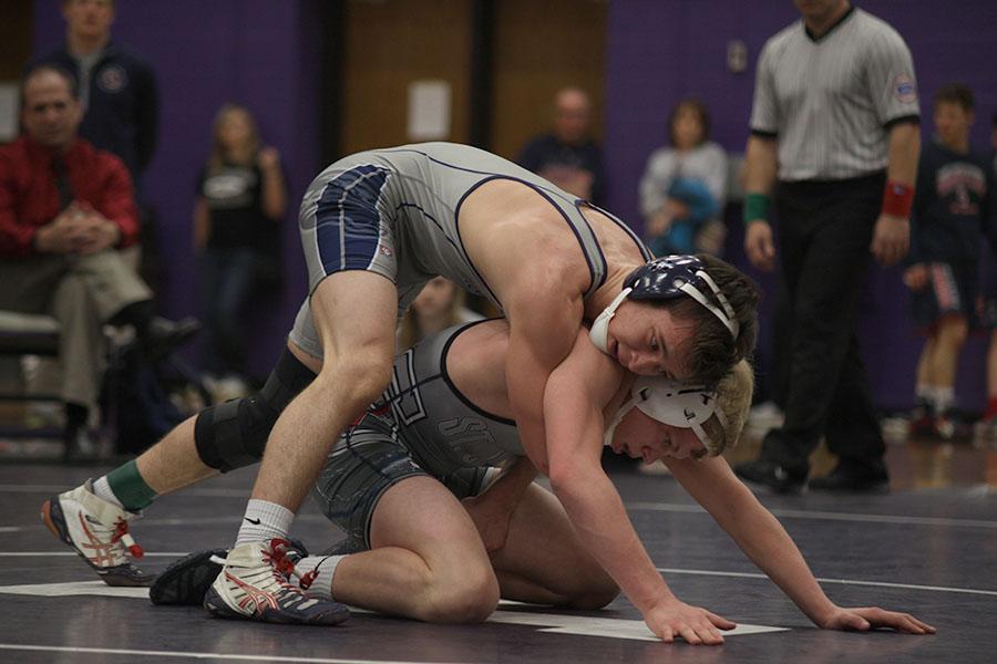 During the 5A regional meet, senior Tyler Dickman wrestles a St. James opponent to win the 138 weight class title. The team beat the #1 ranked St. James for the regional championship, qualifying 12 wrestlers for the state meet.
