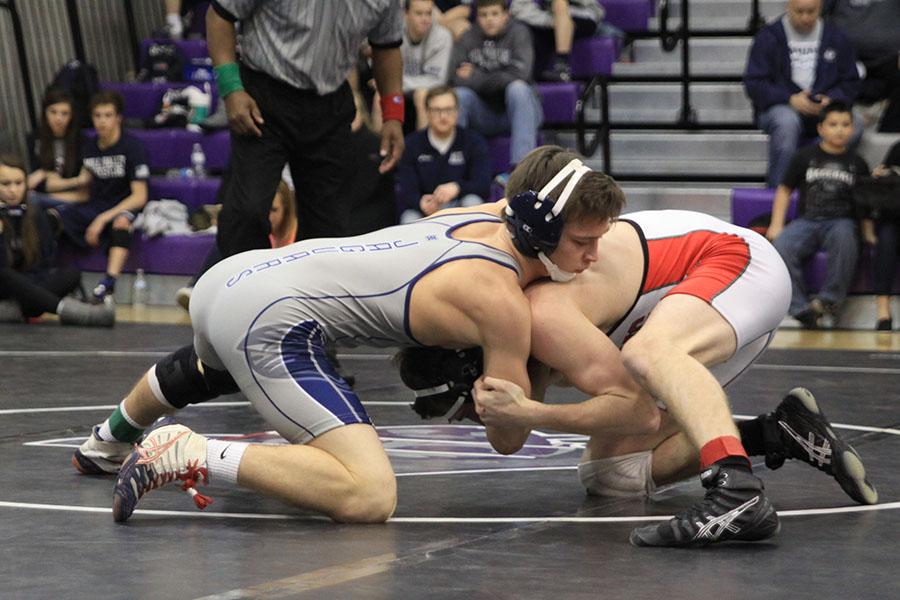 Senior Tyler Dickman wrestles against a Lansing opponent during the KVL league championships on Saturday, Feb. 15 to be first in the 138 weight class.