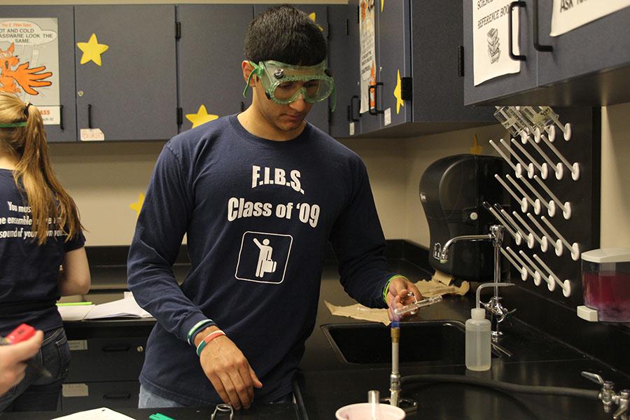 Students work to test chemical reactions to fire on Tuesday, March 11.