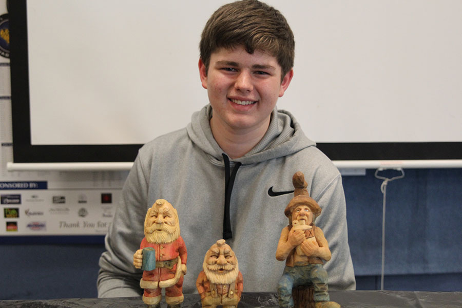 Displaying his original wooden carvings, freshman Austin Snyder spends his free time delicately carving and painting his handmade figurines. 