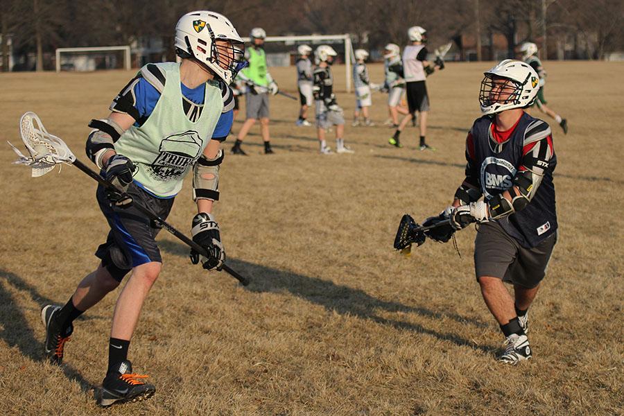 In a one on one scrimmage, sophomore Austin Mackey tries to score while junior Josh Orbin defends the goal. 