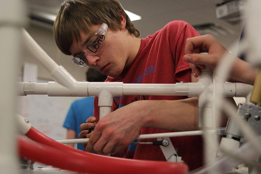 With the robotics build season winding down, 
junior Kyal Long puts the finishing touches 
on the team’s robot on Thursday, Feb. 20. 
