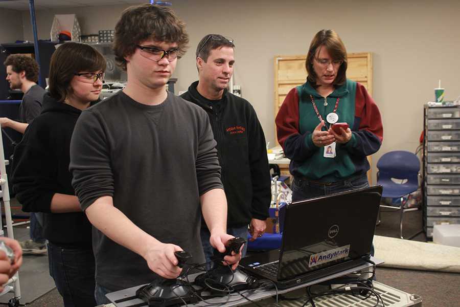 Sophomore Rhett Pierce controls the robotics teams newest robot as the team puts on the final touches before their next competition.