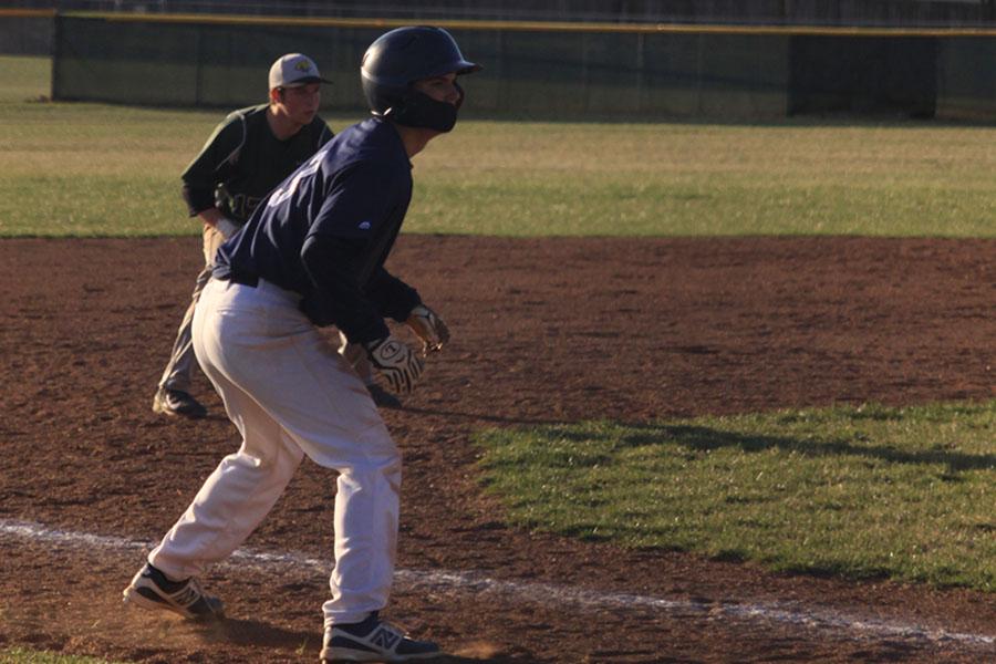 Sophomore AJ Knight leads off on third base in order to advance to home against the Basehor Bobcats on Thursday, April 9.