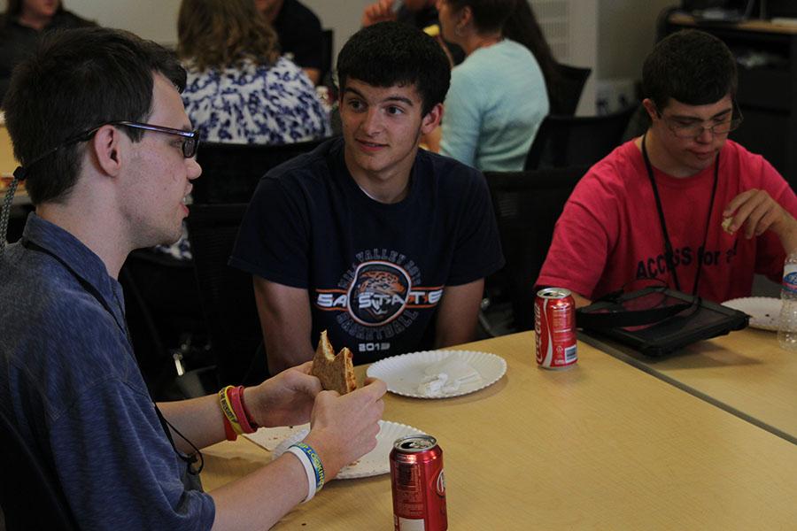 Senior Alex Gray, member of the Catty Shack staff, enjoys lunch with students of the ACCESS house on Friday, May 9. 
