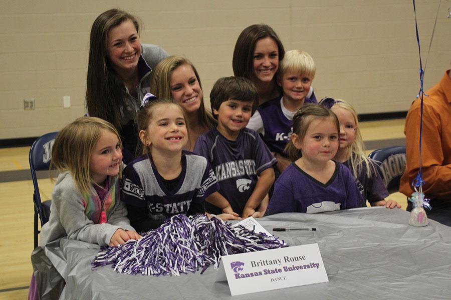 Senior Brittany Rouse signs to dance at Kansas State University surrounded by friends and family at a signing ceremony on Wednesday, April 30. Rouse is excited to meet new people not he team. Im really looking forward to meeting friends, Rouse said. The people Ill be on the team with I think will be my friends for life, and thats exciting for me.