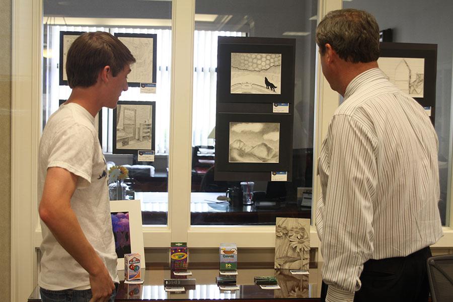 Students present their artwork at the Country Club Bank for an art show on Thursday, May 8.