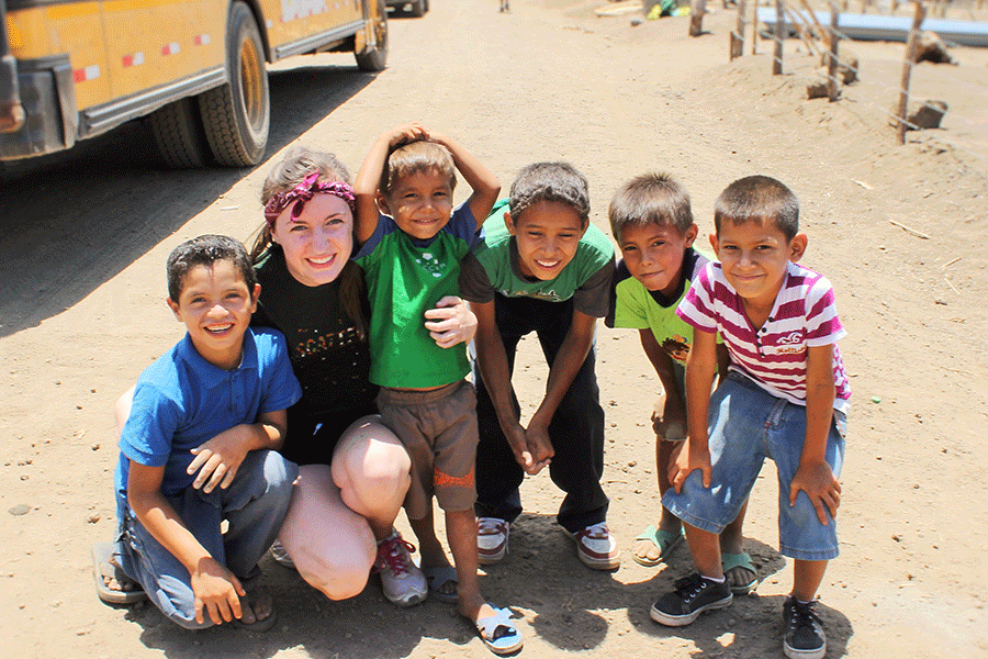  On Tuesday, May 27, senior Laura Earlenbaugh poses for a photograph with villagers in Managua, Nicaragua.