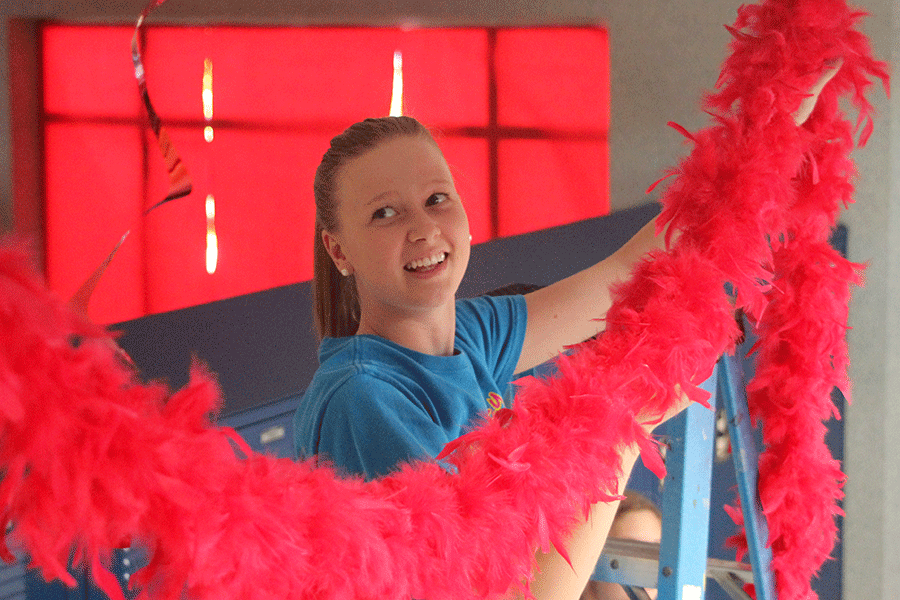 Junior Natalie Golden decorates with her classmates in preperation for Homecoming week on Sunday, Oct. 6.