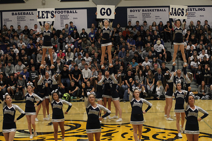 The+cheerleading+squad+performs+a+stunt+during+the+Homecoming+pep+assembly+on+Friday%2C+Oct.+10.
