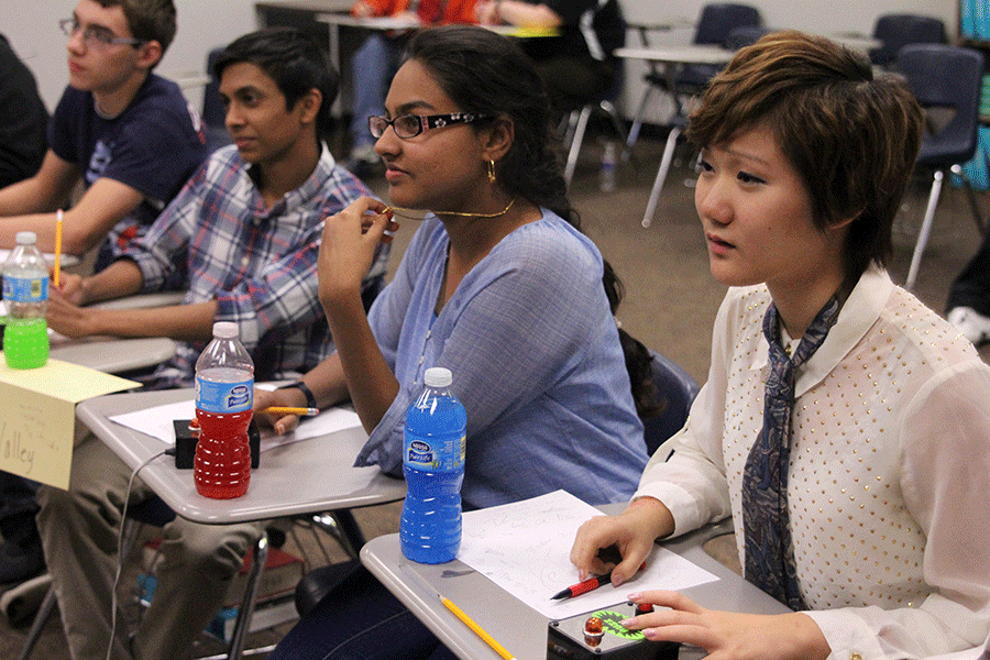 At+the+Quizbowl+tournament+at+Bonner+Springs+High+School%2C+team+members+focus+on+the+question%2C+fingers+ready+to+hit+their+buzzers.