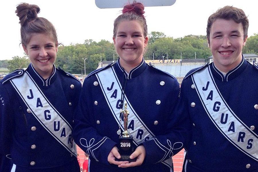 Drum majors junior Lindsey Hamner, senior Kaia Minter, and senior Clayton Kistner pose with the marching band trophy. (photo contributed by Clayton Kistner)