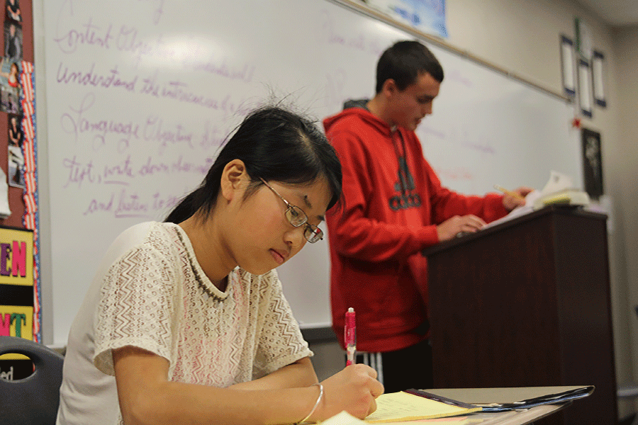 While preparing for her next argument, freshman Wendy Chen takes notes over key points made by freshman Justin Grega during class on Wednesday, Nov. 5.