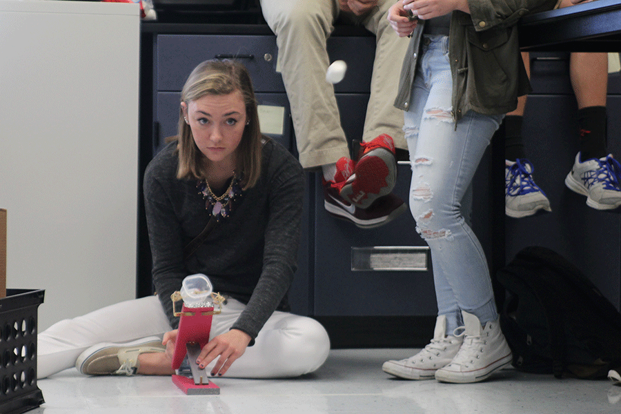 While releasing the cup of her marshmallow launcher for a physics project, junior Lizzy Eber watches as her marshmallow flies through the air on Wednesday, Nov. 5.