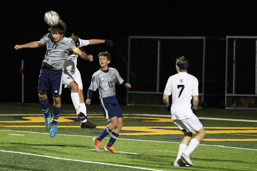 Reaching the ball before the other players, senior Bailey Weeks overturns the ball to the aid his teammates defensively against Saint Thomas Aquinas on Tuesday, Nov. 4.