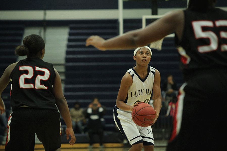 At the girls basketball game on Friday, Dec. 5, senior Jabria Leggett prepares to shoot. 