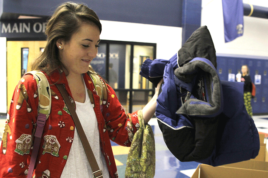 Senior Taylor Felshaw donates a coat to help her grade win class cup points.
