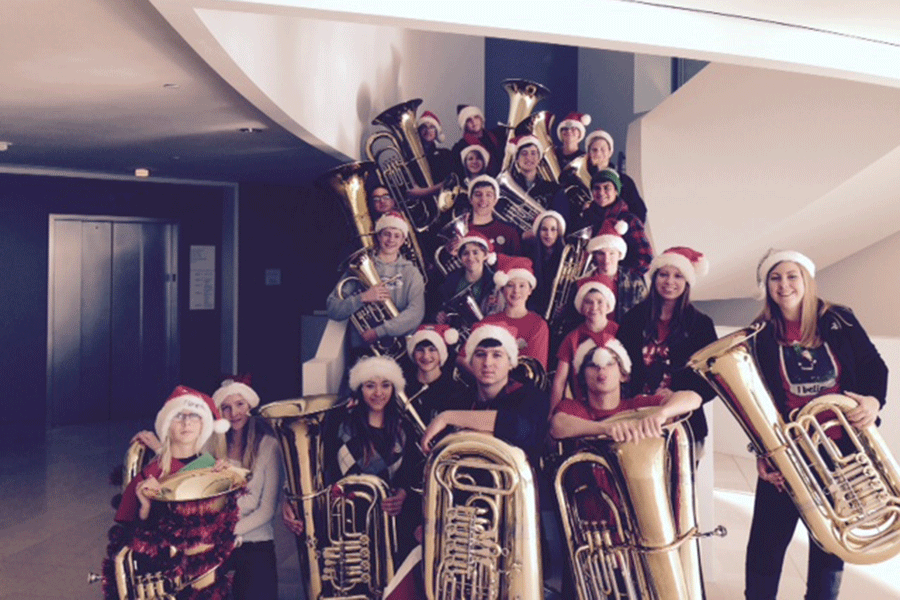 Students pose with their interments after performing in the Tuba Christmas Holiday event on Monday, Dec. 8.