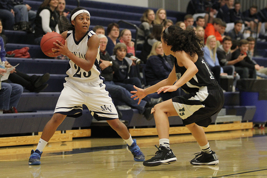 Senior Jabria Leggett searches for an open pass against Lawrence Free State on Friday, Dec. 12. 