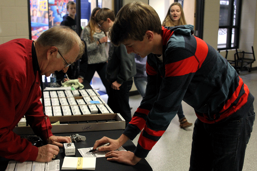 During lunch on Tuesday, Dec. 9, sophomore Spencer Butterfield picks up his class ring.