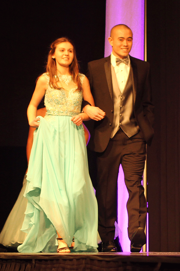 Junior Chase Midyette escorts another model down the runway on Sun, January 11.