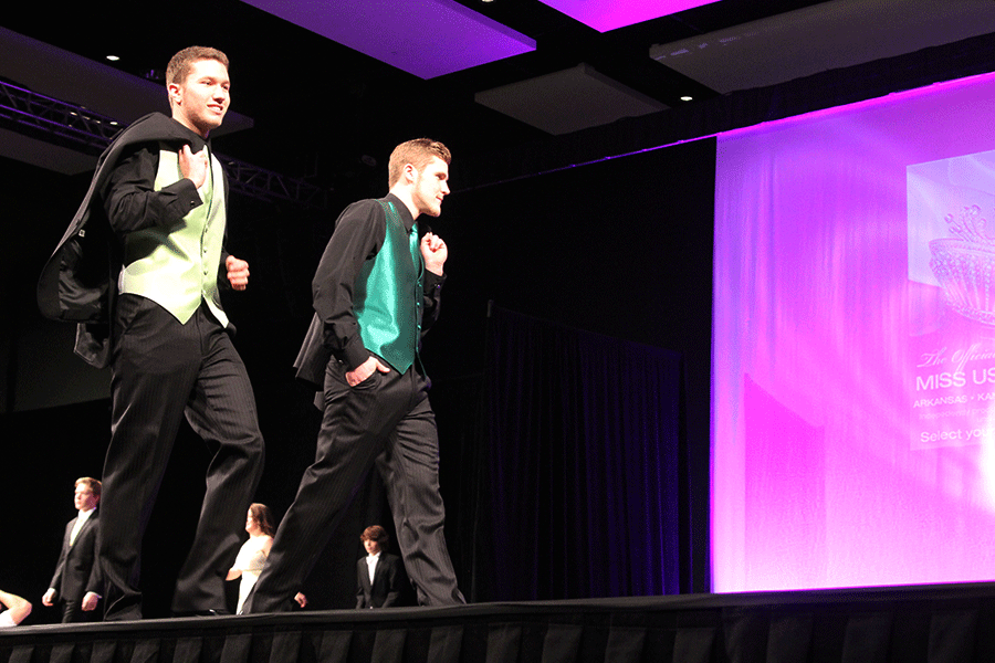 Senior Cody Deas models a green suit along with another model on Sun, January 11.