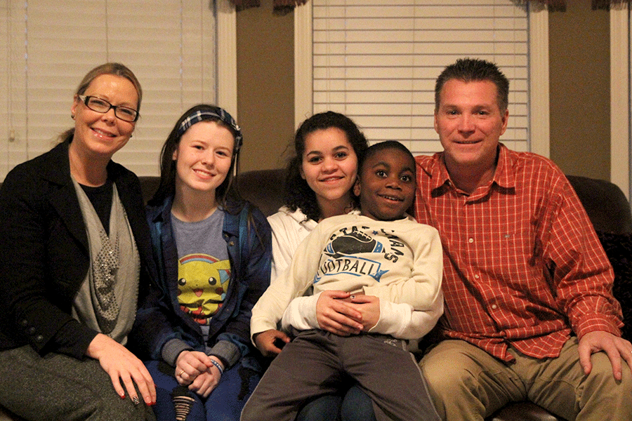Senior Peyton Barton sits by her mother Vicki, sister Presley, brother Muunjuza and her father Terry on Wednesday Jan. 13 and discusses each of their adoption stories.
