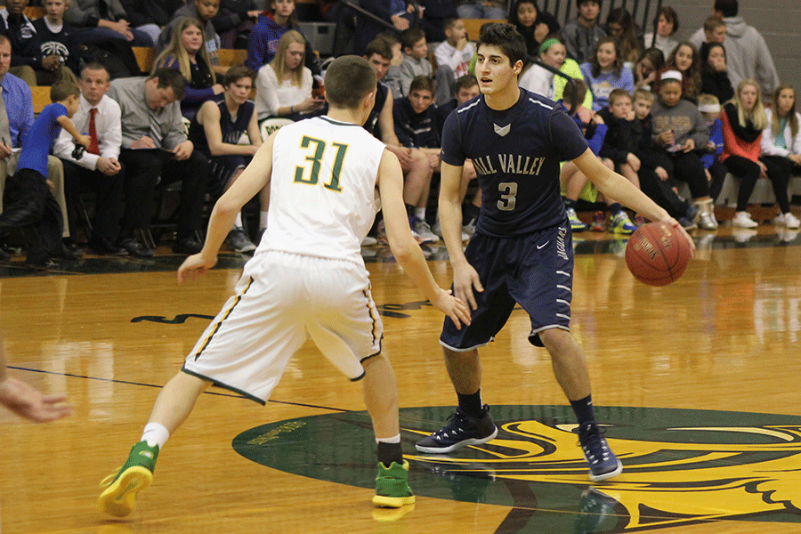 As he looks to pass to a teammate, senior Evan Kopatich brings up the ball in a basketball game against Basehor-Linwood on Tuesday, Jan. 6. The Jaguars fell to the Bobcats, 59-47.