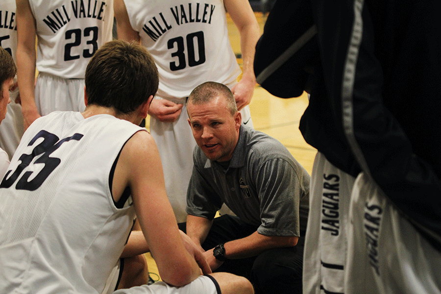 Boys+head+varsity+coach+Mike+Bennett+gives+words+of+encouragement+to+the+players+during+the+basketball+game+against+Bishop+Ward+on+Saturday%2C+Jan.+17.+The+Jaguars+defeated+the+Bishop+Ward+Cyclones%2C+62-39.