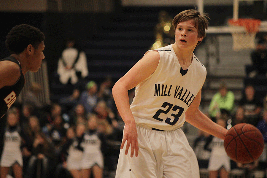 Bringing the ball down the court, freshman Cooper Kaifes calls out the play during the basketball game against the Bonner Springs Braves on Friday, Jan. 9. The Jaguars fell to the Braves, 72-64, in double overtime.