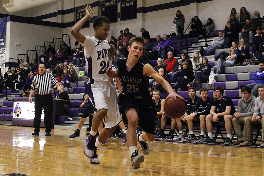 Junior Jaison Widmer drives to the basket in the basketball game against Piper on Monday, Jan. 12. The Jaguars fell to the Piper Pirates, 68-63, in double overtime. 