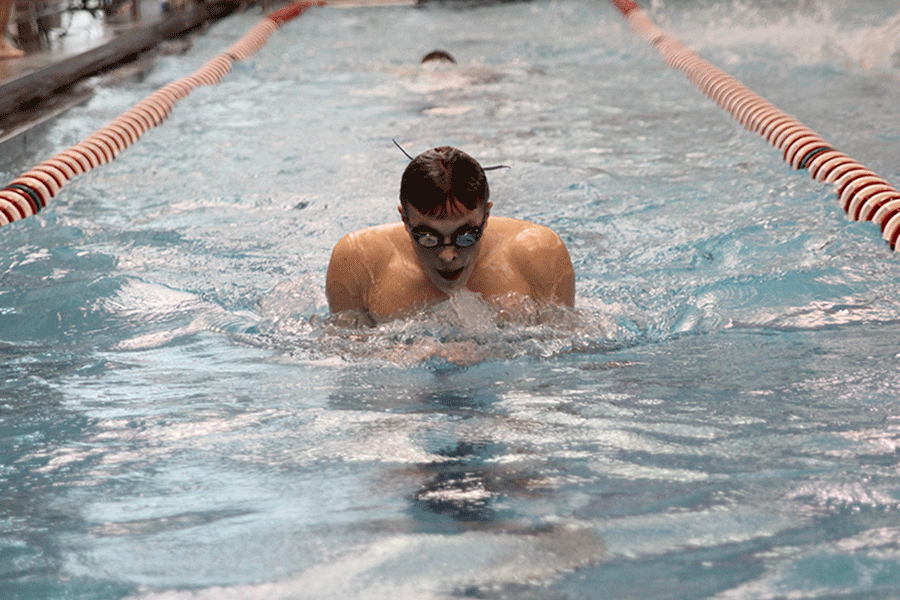 Senior Nick Stack warms up before the boys swim meet on Thursday, Jan. 29. 