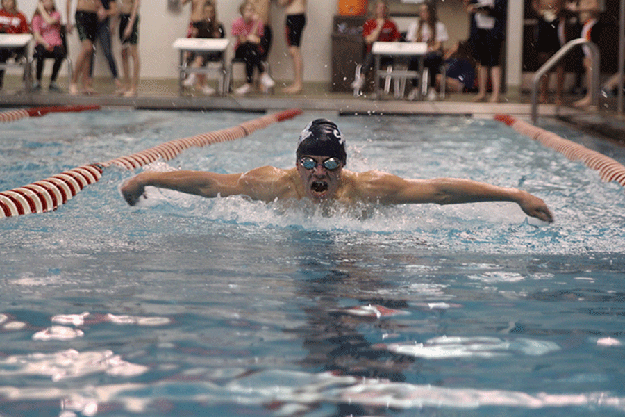 Junior Adam Grey participates a race at the boys swim meet on Thursday, Jan. 29.