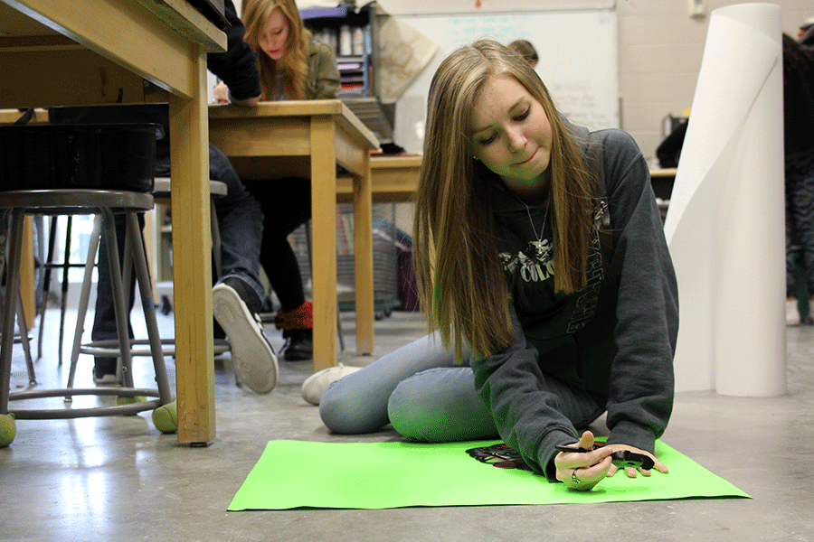 Junior representative Megan Feuerborn decorates a poster to advertise Winter Homecoming spirit days on Thursday, Jan. 8. Choosing the theme and spirit days to go with it is my favorite part of the planning. I think [the 80s theme] will make it easier for students to dress up for, Feuerborn said. I think there will be more participation, and it should be pretty fun to decorate for.