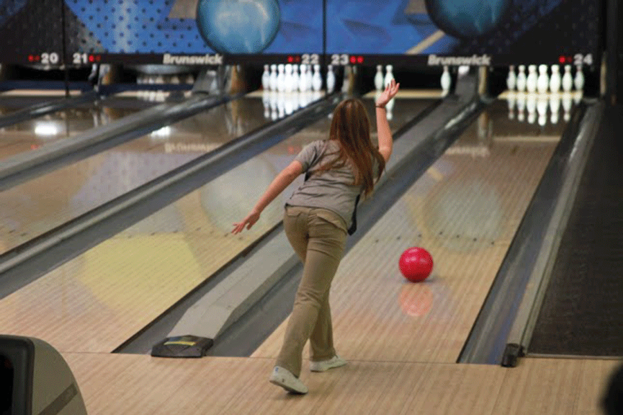 Freshman Emily Jackson rolls one of many strikes to help her team advance through the qualifying game against St. James at Royal Crest Lanes on Saturday, Jan. 10.